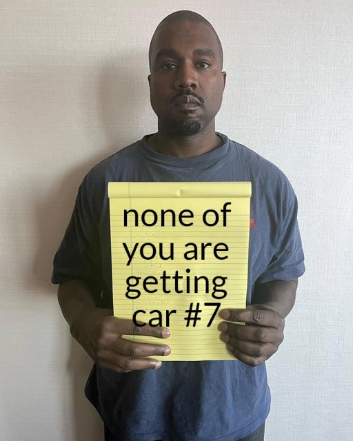 Kanye West Holding Notepad 18032023165820.jpg